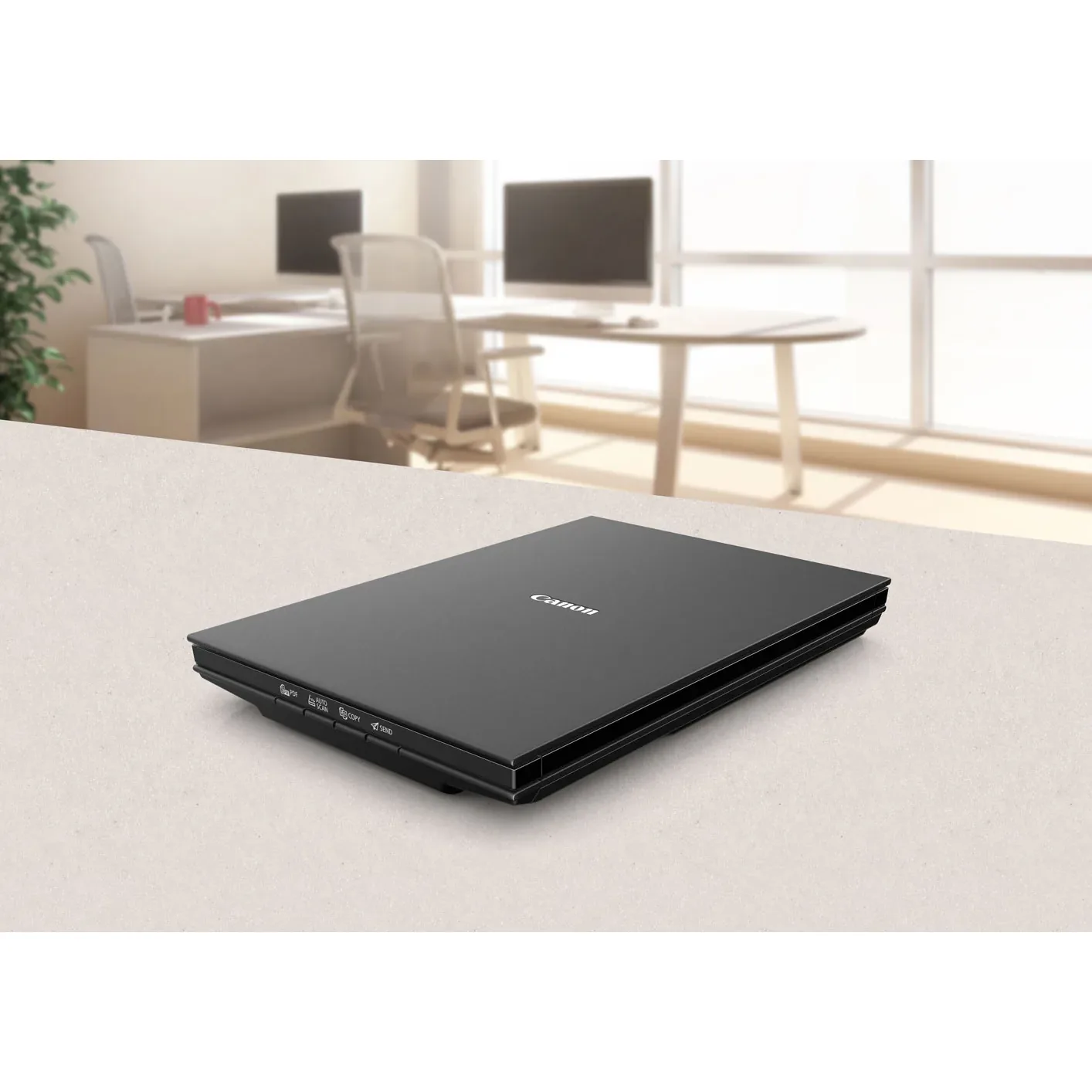 Canon CanoScan LiDE 300 scanner closed on an office desk