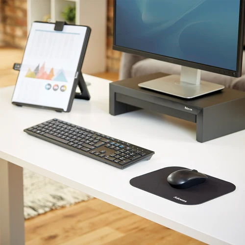 Fellowes black mouse pad on an office desk