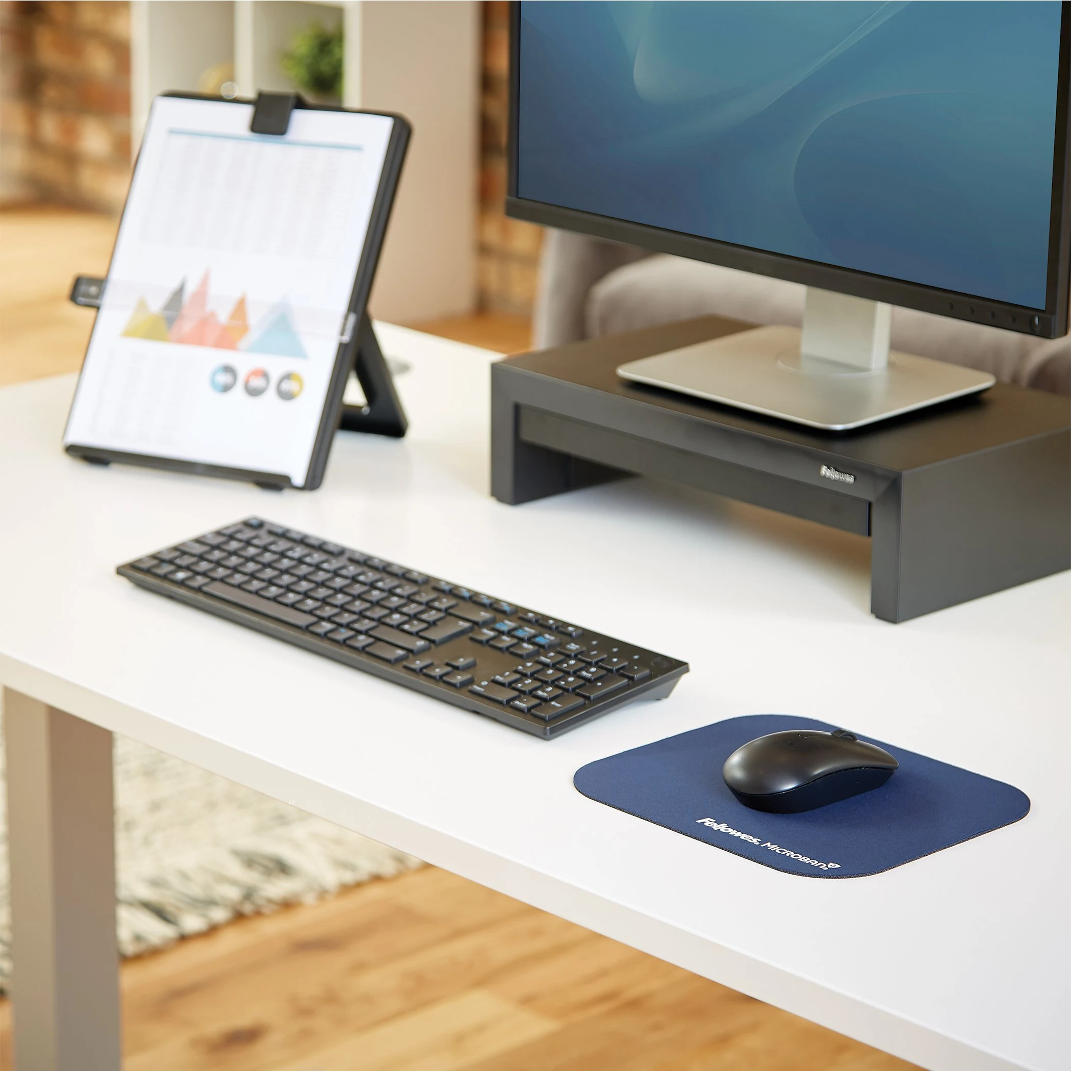 Fellowes Microban blue mouse pad on an office desk