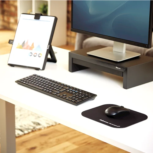 Fellowes Microban black mouse pad on an office desk
